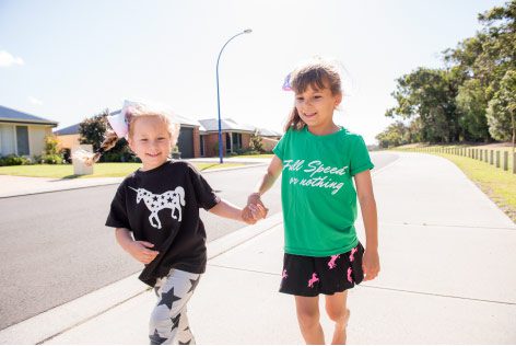 kids in Kingston Estate holding hands near new houses and new facilities
